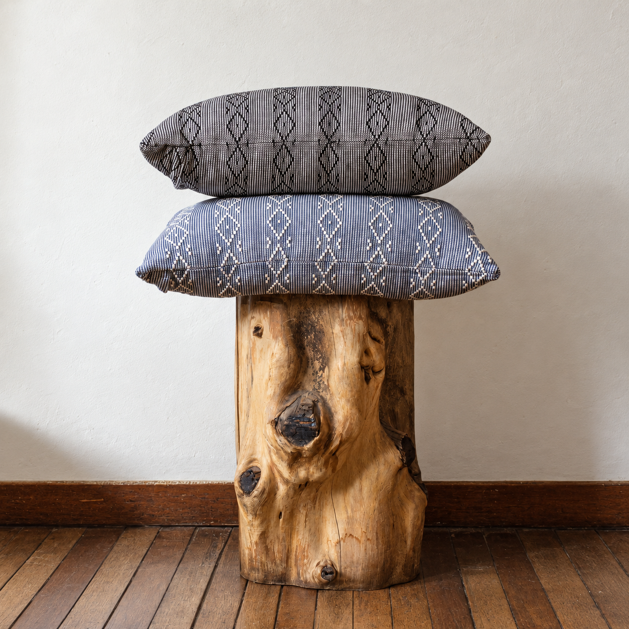 Dos riñoneras Bordadas de Dilia Suárez en tonos azul y gris sobre bancos de madera